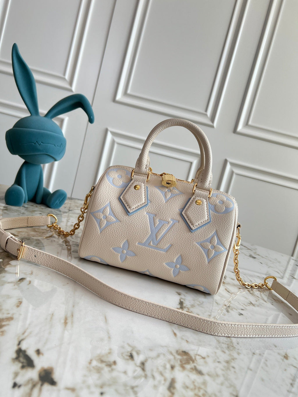 Light-colored embossed leather mini handbag
